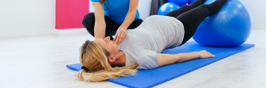 Pregnant woman exercising with ball.