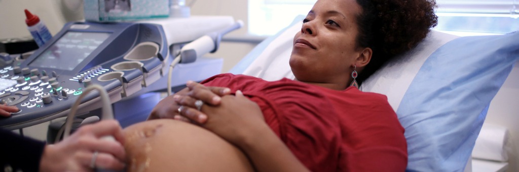 Pregnant woman having ultrasound scan.