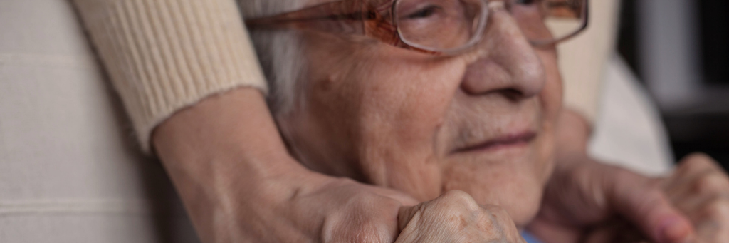 Holding hands with elderly man