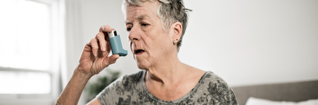 Woman uses inhaler to manage lung condition