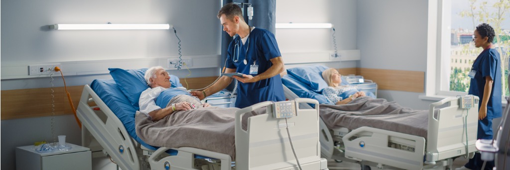 Nurse treats a patient in intensive care