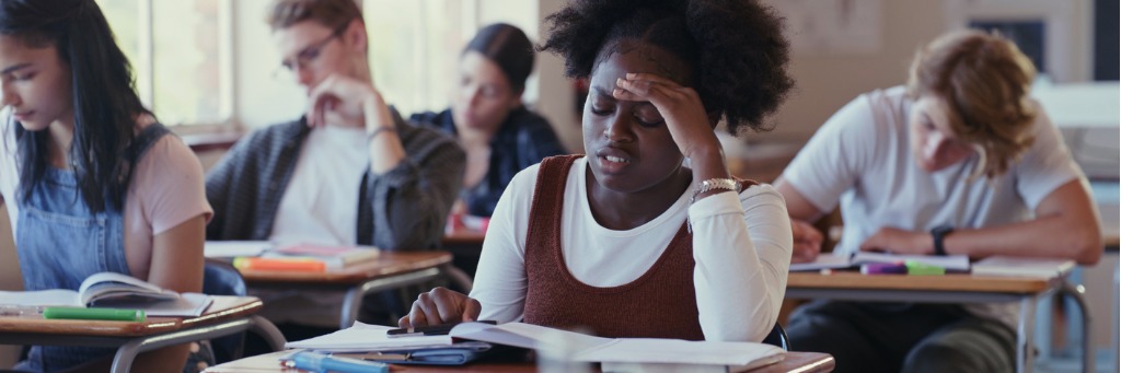 Student concentrating in classroom.