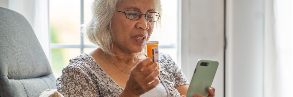 Woman checking medication on phone.