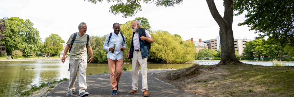 Three men walking in park