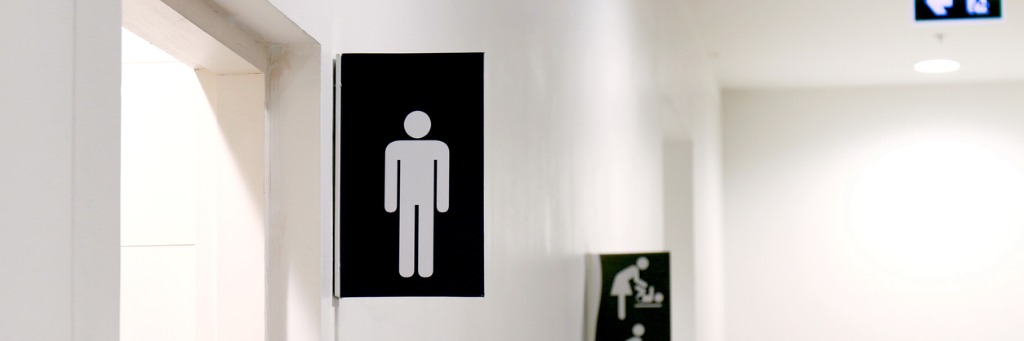 Men's toilet sign on wall.