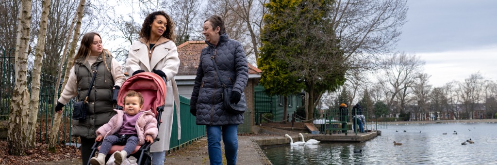 Women walking by a lake.