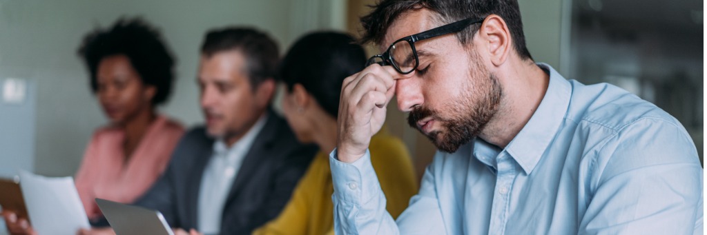 Stressed man in meeting room.